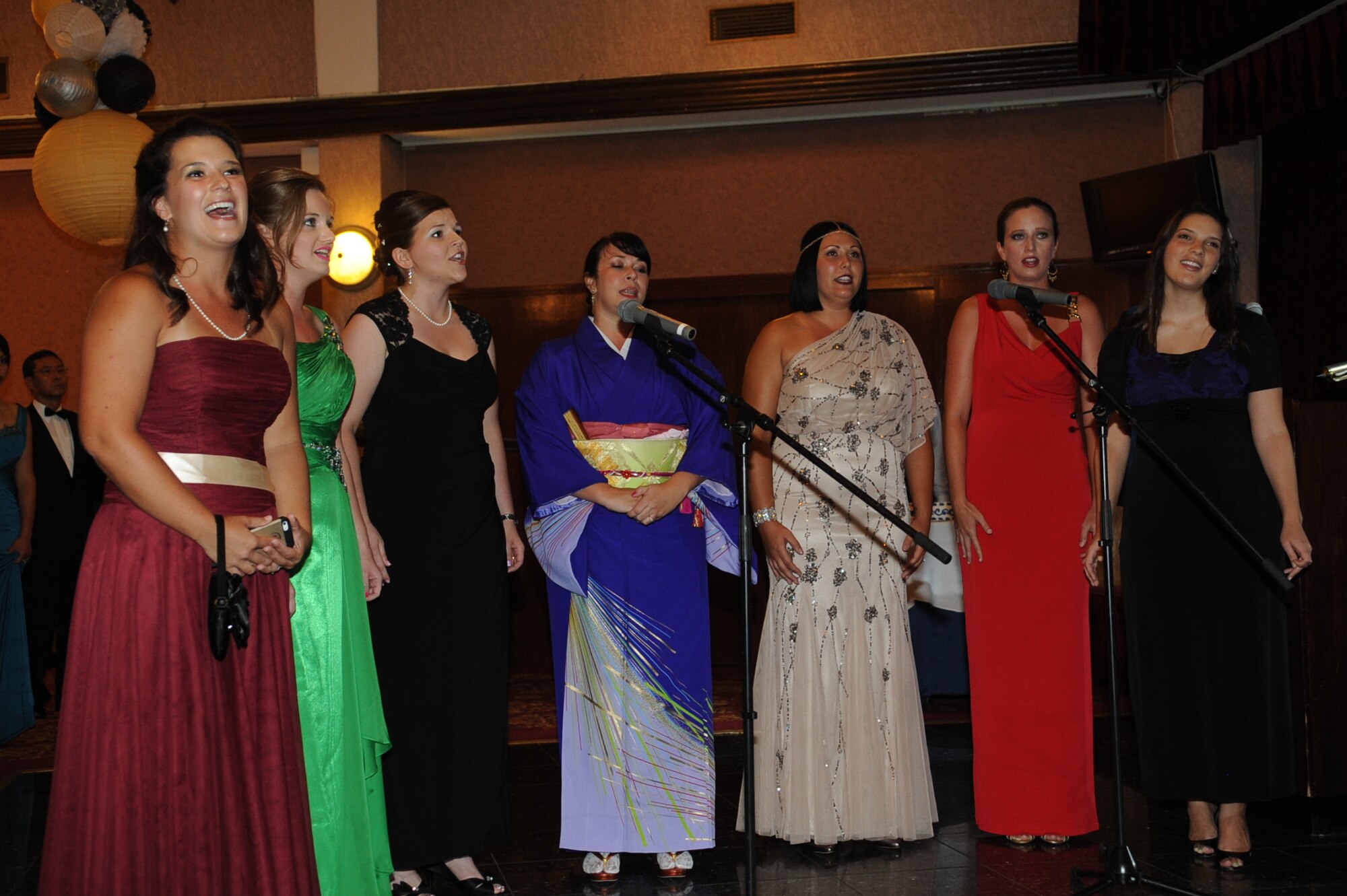 Kadena Harmony, a choral group, sings the U.S. national anthem preceding the 2014 Air Force Ball on Kadena Air Base, Japan, Sept. 13, 2014. This year's theme, "Honoring our past, preserving our future," honored the people and events that shaped the Air Force and this celebration marks the 67th birthday of the Air Force. (U.S. Air Force photo by Airman 1st Class Zackary A. Henry/Released)