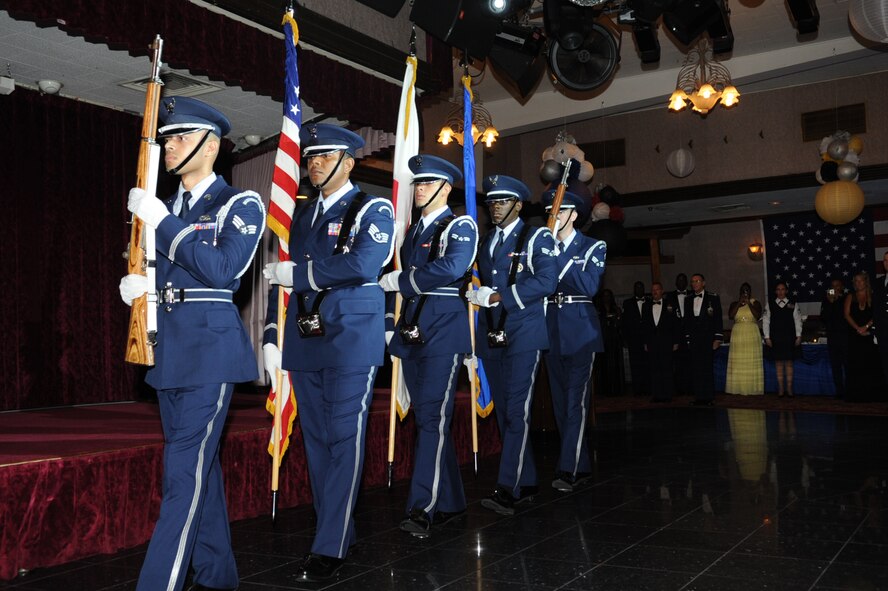 Kadena's Honor Guard present the colors during the U.S. and Japanese national anthems preceding the 2014 Air Force Ball on Kadena Air Base, Japan, Sept. 13, 2014. This year's theme, "Honoring our past, preserving our future," celebrated the people and events that shaped the Air Force through the years. (U.S. Air Force photo by Airman 1st Class Zackary A. Henry/Released)