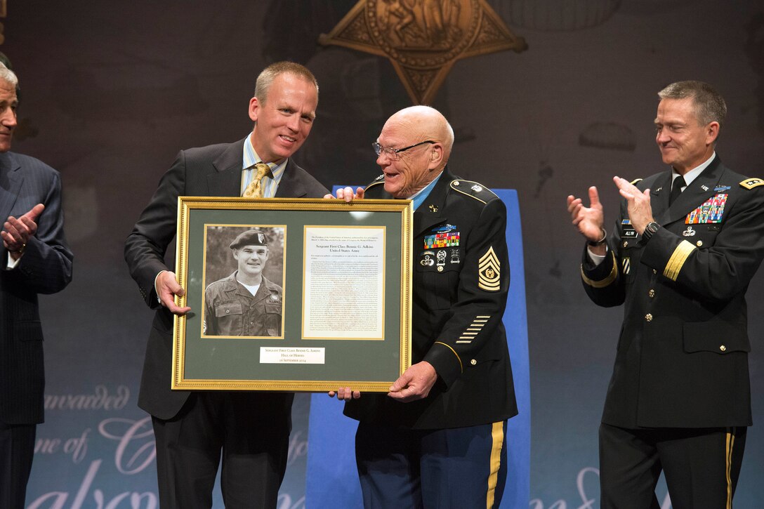Undersecretary of the Army Brad R. Carson, left, and Vice Chief of Staff of the Army Gen. Daniel B. Allyn, right, join retired Army Command Sgt. Maj. Bennie G. Adkins during the Hall of Heroes ceremony at the Pentagon, Sept. 16, 2014. 