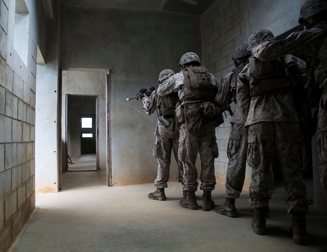 Marines with Weapons Company, 1st Battalion, prepare to clear a room Aug. 20 at the Central Training Area during military operations on urbanized terrain. The training package included room clearing procedures, breaching techniques and patrolling skills. The Marines are anti-tank missilemen with Weapons Co., 1st Battalion, 3rd Marine Regiment, currently assigned to 4th Marine Regiment, 3rd Marine Division, III Marine Expeditionary Force, under the unit deployment program. (U.S. Marine Corps photo by Lance Cpl. Devon Tindle/Released)