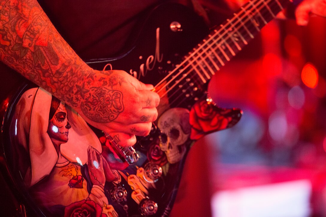 Marcos Curiel, the guitarist for the band P.O.D., plays his guitar during Hansen Fest Sept. 13 on the Camp Hansen Parade Field. The band played multiple songs including their hit single, “Youth of the Nation.” The free concert was open to service members, their families and community members during the annual festival. “A lot of our fan base has been people in the military, and some of the service members say our music has changed their lives,” said Sonny Sandoval, the vocalist for P.O.D. (U.S. Marine Corps photo by Lance Cpl. Ryan C. Mains/Released)
