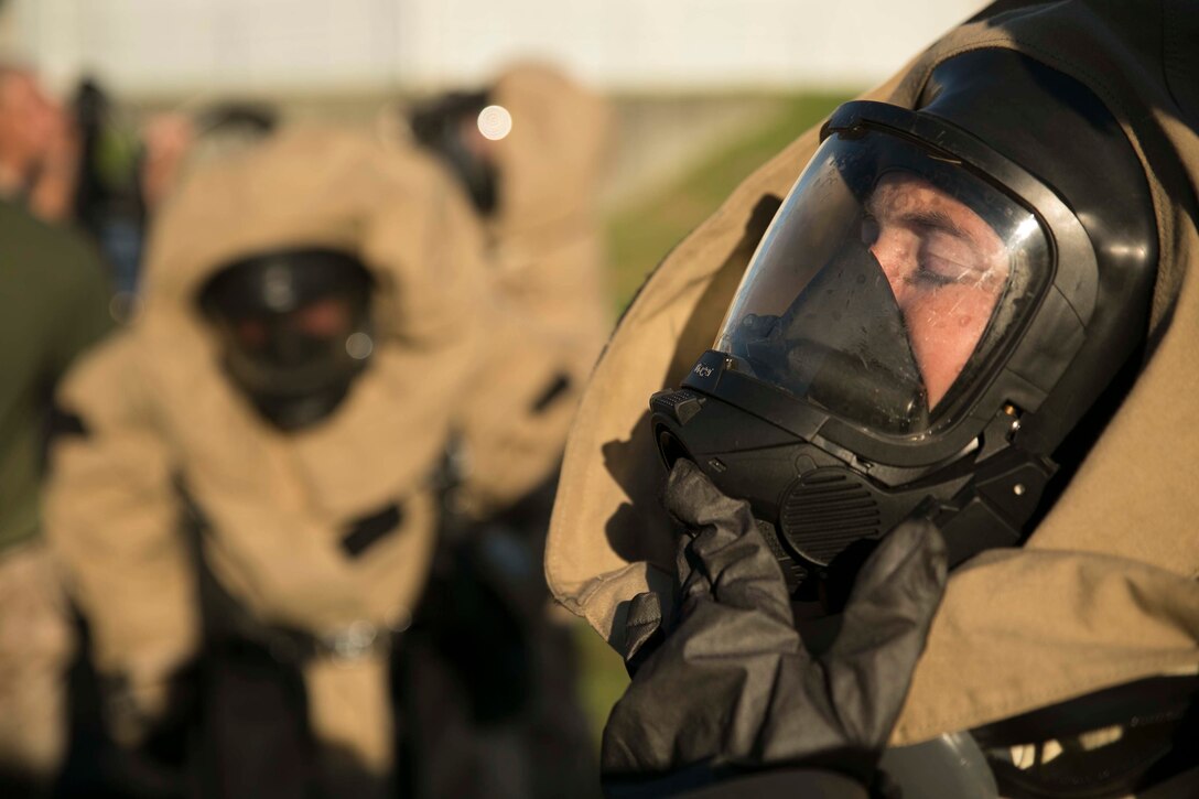 Lance Cpl. Brittny A. Williams, from Riverside, California, puts on her gas mask during an assessment and consequence management response training event Aug. 27 at Marine Corps Air Station Futenma. Williams and her fellow Marines were suiting up to respond to simulated hazardous materials. Williams is a chemical, biological, radiological and nuclear defense specialist with Marine Wing Headquarters Squadron 1, 1st Marine Aircraft Wing, III Marine Expeditionary Force. 