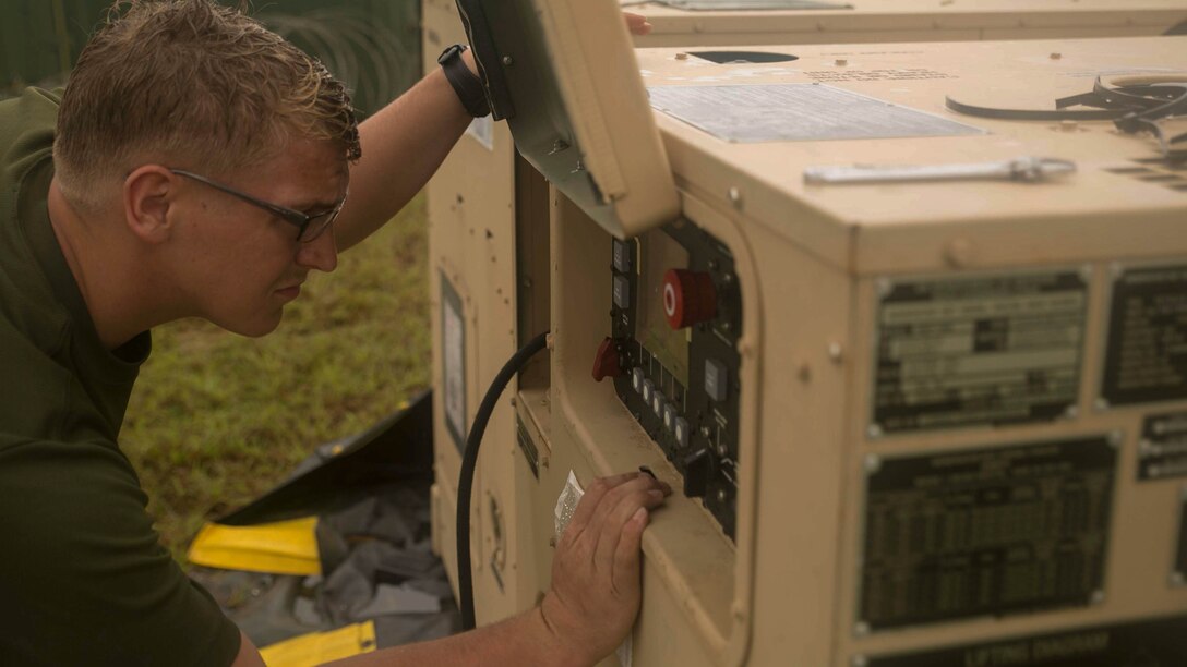 Cpl. Jeremiah D. Dorf, a generator mechanic, from Paynesville, Minn., with Marine Air Control Squadron 4, Marine Air Control Group 18, 1st Marine Aircraft Wing, III Marine Expeditionary Force, checks the generator connected to meteorological and oceanographic equipment in preparation of Valiant Shield 2014 at Tinian, North Marianas Islands. Valiant Shield is a U.S.-only exercise integrating U.S. Navy, Air Force, Army and Marine Corps assets, offering real-world joint operational experience to develop capabilities that provide a full range of options to defend U.S. interests and those of its allies and partners. (U.S. Marine Corps photo by Lance Cpl. Tyler Ngiraswei/ Released)