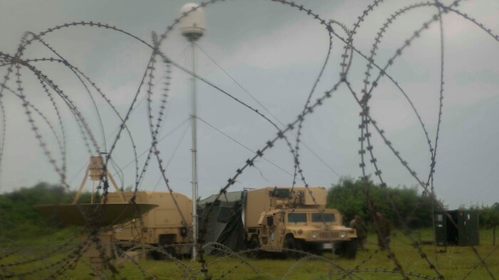 Marines set up concertina wire around a weather observation compound in preparation of Valiant Shield 2014 at Tinian, North Marianas Islands. Valiant Shield is a U.S.-only exercise integrating U.S. Navy, Air Force, Army and Marine Corps assets, offering real-world joint operational experience to develop capabilities that provide a full range of options to defend U.S. interests and those of its allies and partners. (U.S. Marine Corps photo by Lance Cpl. Tyler Ngiraswei/ Released)