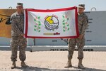 Sgt. 1st Class Lowell Laudert, an intelligence analyst with the 34th Combat Aviation Brigade of the Minnesota National Guard, and his brother, Spc. Cameron Laudert, a health care specialist with the 452nd Combat Support Hospital, U.S. Army Reserve, show their respect for their Native American heritage, displaying the White Earth Nation flag. They are deployed to Camp Buerhing in support of Operation Enduring Freedom-Kuwait. 