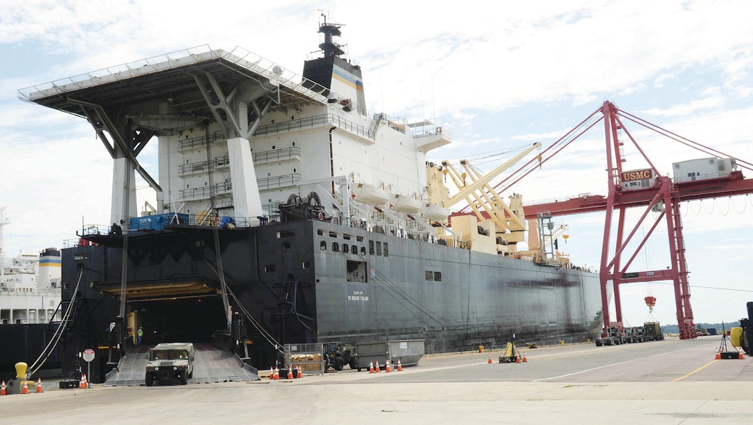 A dockworker with the Jacksonville, Fla., company, Portus, drives a Humvee through the stern of the United States Navy Ship Pfc. Dewayne T. Williams’ at Blount Island Command, Jacksonville, in early September. Other dockworkers removed large metal containers filled with all types of military gear from within the vessel, known as a maritime prepositioning ship, with heavy-duty cranes.