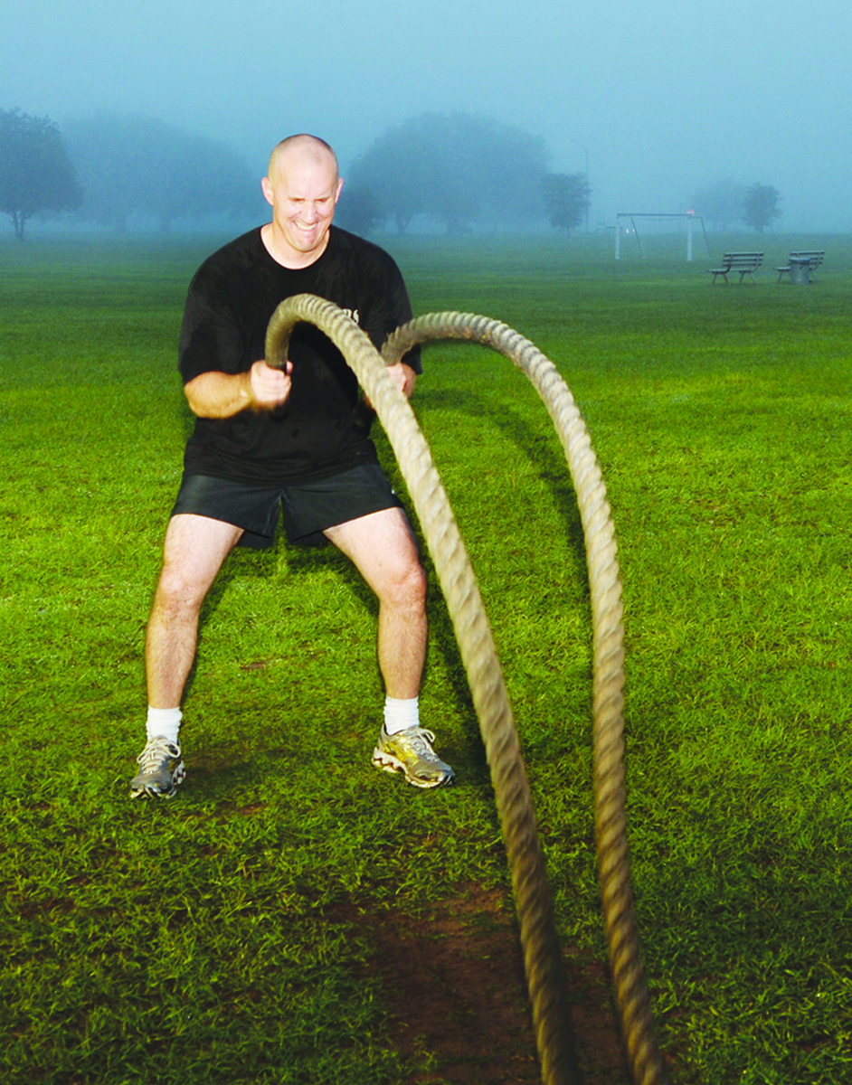 Maj. Walter Wilkie, staff judge advocate, Marine Corps Logistics Base Albany, performs a round of battle roping during his early morning High Intensity Tactical Training recently at Covella Pond aboard MCLB Albany.