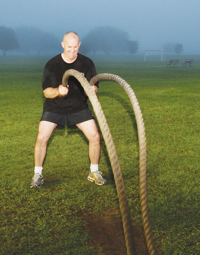 Maj. Walter Wilkie, staff judge advocate, Marine Corps Logistics Base Albany, performs a round of battle roping during his early morning High Intensity Tactical Training recently at Covella Pond aboard MCLB Albany.