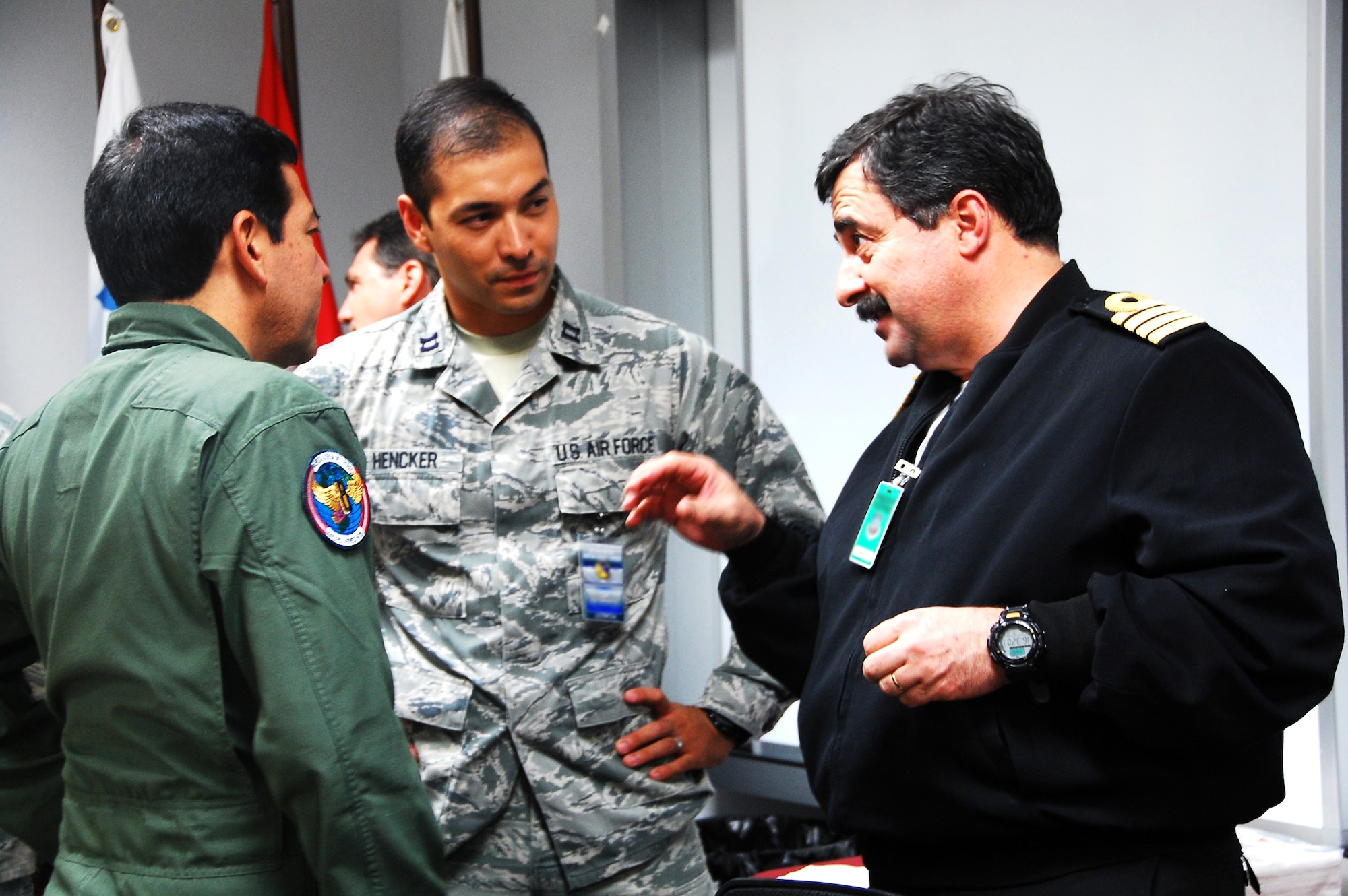 Capt. de Navio Gonzalo Ciganda, the Naval Aviation Group commander from Uruguay (right), talks to Capt. Luis Hencker, U.S. Southern Command (center), and Col. Cesar Macedo, 2nd Air Wing commander from Peru (left) during a break in the first, Spanish-language Building Partners Aviation Capacity Course Sept. 9, 2014 at the U.S. Air Force Special Operations School, Hurlburt Field, Fla. The BPACC is a two-week course bringing together partner nation representatives with their U.S. counterparts and building a shared, practical vision for aviation resource development.  This iteration, which met Sept. 8-19, brought in 14 international students from nine allied countries as well as a select group of 22 U.S. students. (U.S. Air Force photo by Lori Werth)