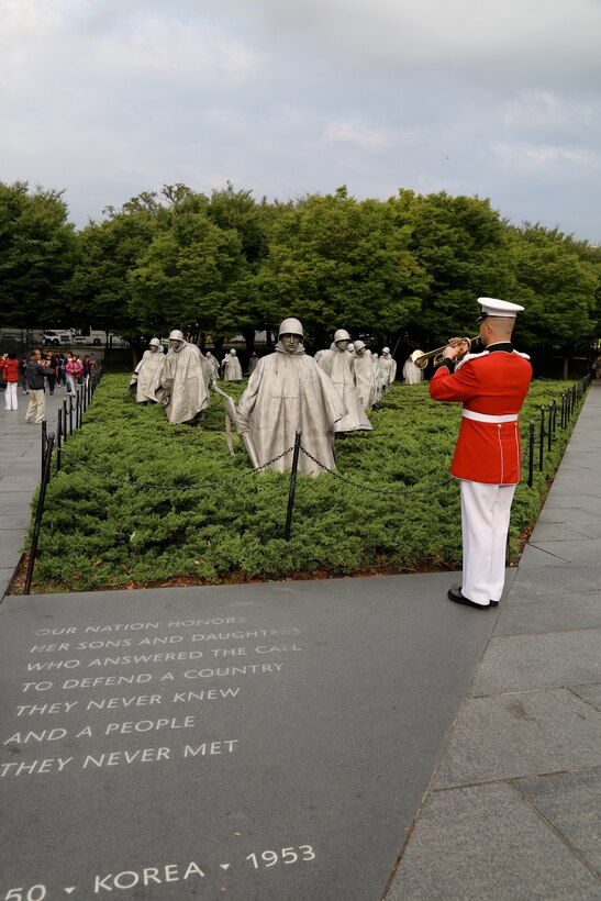 On Sept. 18, 2014, Staff Sgt. Michael Warnick performed Taps at the Korean War Veterans Memorial and the Vietnam Veterans Memorial for an Honor Flight from Odessa, Texas. This was the first Honor Flight from the Permian Basin region and included veterans from World War II, Korea, and Vietnam. (U.S. Marine Corps photo by Master Sgt. Kristin duBois/released)