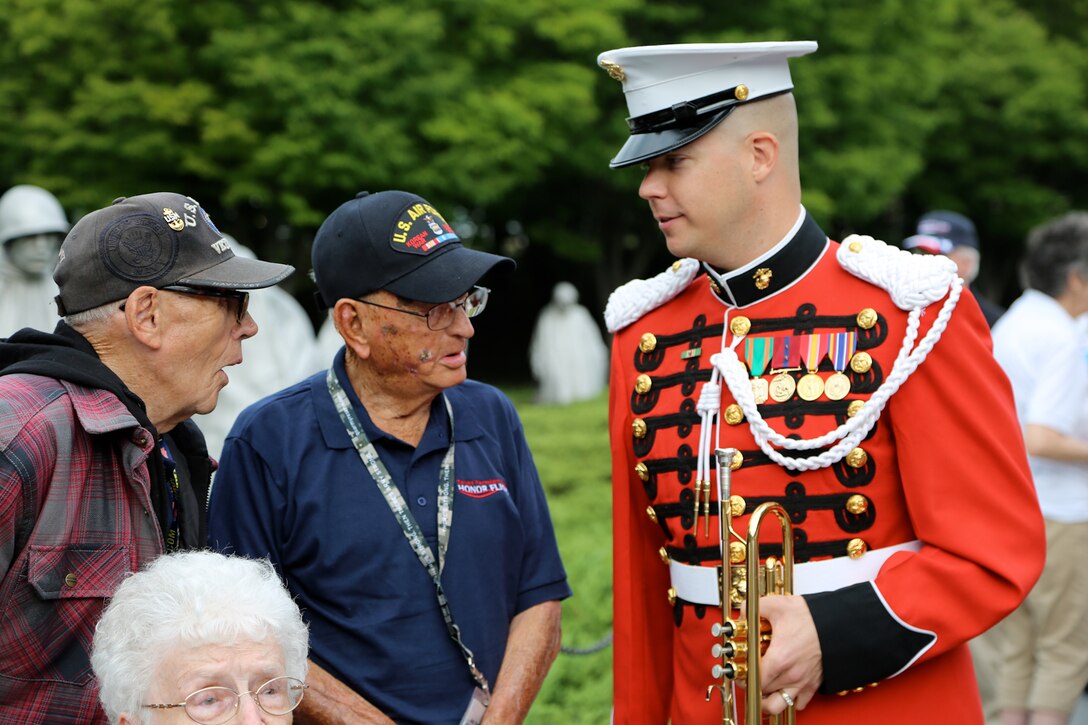 On Sept. 18, 2014, Staff Sgt. Michael Warnick performed Taps at the Korean War Veterans Memorial and the Vietnam Veterans Memorial for an Honor Flight from Odessa, Texas. This was the first Honor Flight from the Permian Basin region and included veterans from World War II, Korea, and Vietnam. (U.S. Marine Corps photo by Master Sgt. Kristin duBois/released)