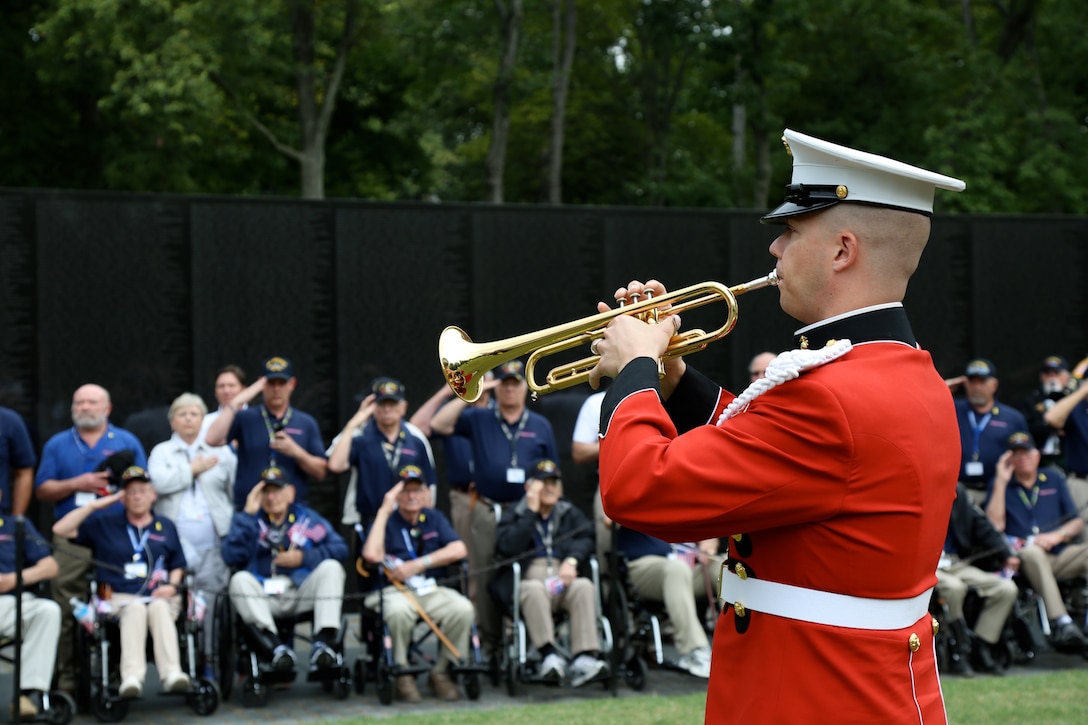 On Sept. 18, 2014, Staff Sgt. Michael Warnick performed Taps at the Korean War Veterans Memorial and the Vietnam Veterans Memorial for an Honor Flight from Odessa, Texas. This was the first Honor Flight from the Permian Basin region and included veterans from World War II, Korea, and Vietnam. (U.S. Marine Corps photo by Master Sgt. Kristin duBois/released)