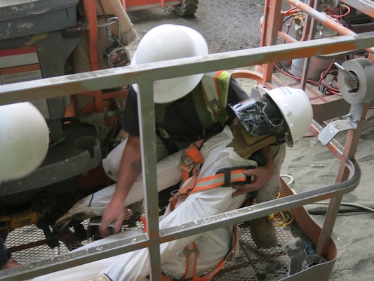 Using a mechanical lift, one employee transported the victim from the spillway floor to the top of the wing wall. While the victim was in transit, employees on the spillway floor made their way to the top of the wing wall to assist in transporting the victim from the lift.