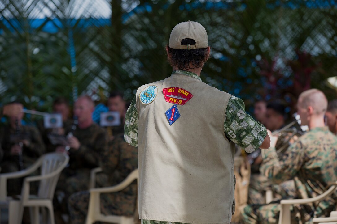 A former active-duty Marine from the 1st Marine Division observes members of the U.S. Marine Corps Forces, Pacific Band practice prior to the 70th Anniversary of the Battle of Peleliu ceremony, Sept. 15, on the Island of Peleliu, Palau. The anniversary marks the landing on Peleliu, in which Marines for the 1st Marine Division fought in and was one of the bloodiest battles during World War II in the Pacific. Both citizens and veterans from Japan and the U.S. were present at the ceremony.