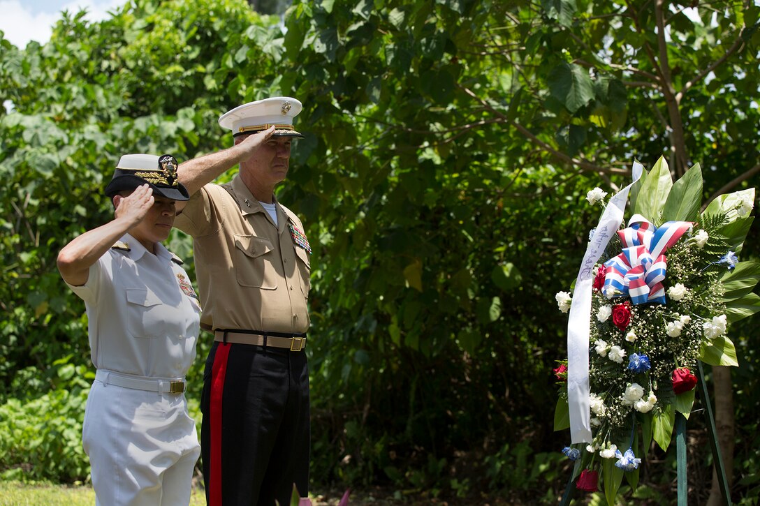 Rear Adm. Babette "Bette" Bolivar, commander of Joint Regions Marianas, and Maj. Gen. Charles L. Hudson, commander of Marine Corps Installations, Pacific salute a wreath presented at the 81st Army Infantry Regiment Memorial, Sept. 15, during a tour of the memorial sites on Peleliu. This year marks the 70th Anniversary of the landing on Peleliu, which turned into the 'bitterest battle for the Marines' during their World War II campaign in the Pacific against the nation of Japan.