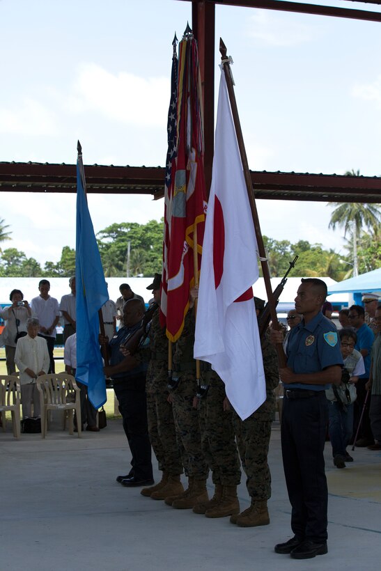 Marines from the U.S. Marine Corps Forces, Pacific Color Guard and police officers from the Palau Police present the organizational colors of MarForPac and the national ensigns of Palau, Japan and the U.S. at the 70th Anniversary Ceremony for the Battle of Peleliu, Sept. 15. Americans, Japanese and local residents were present to recognize the landing that took place 70 years earlier and was known as one of the bloodiest battles Marines had to fight in during their time in the Pacific for World War II.