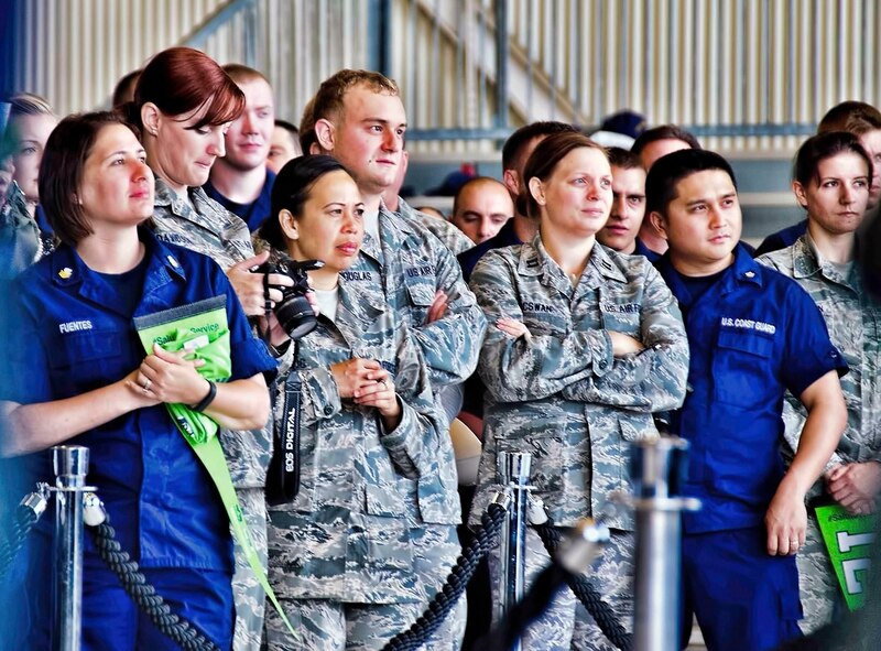 Coast Guardsmen and Airmen stand together as the 446th Airlift Wing hands over the reins as the Seattle Seahawks championship football team's military unit for the season to the Coast Guard District 13 Seattle. The "change of command" ceremony took place at McChord Field, Washington Sept. 9.  Before handing over the flag, 446th Airlift Wing Commander Col. Richard Grayson and Command Chief Master Sgt. Tony Mack thanked the Seahawks for an unbelievable season that concluded at Super Bowl XLVIII in New Jersey with a 43-8 win over the Denver Broncos. (U.S. Air Force Reserve photo by Jake Chappelle)