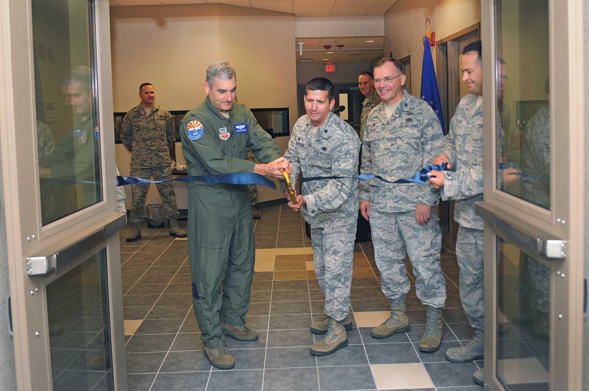 U.S. Air Force Col. Stephen Renner, 355th Fighter Wing vice commander, and Lt. Col. John Gustafson, 355th Logistics Readiness Squadron commander, cut the ribbon during a ceremony at Davis-Monthan Air Force Base, Ariz., Sept. 17, 2014. The event held was to celebrate the opening of the new Fuels Management facility and Type III Fuels Hydrant System facility. The new facilities are equipped with updated fuel systems to increase fuels management productivity. (U.S. Air Force photo by Airman 1st Class Cheyenne Morigeau/Released) 