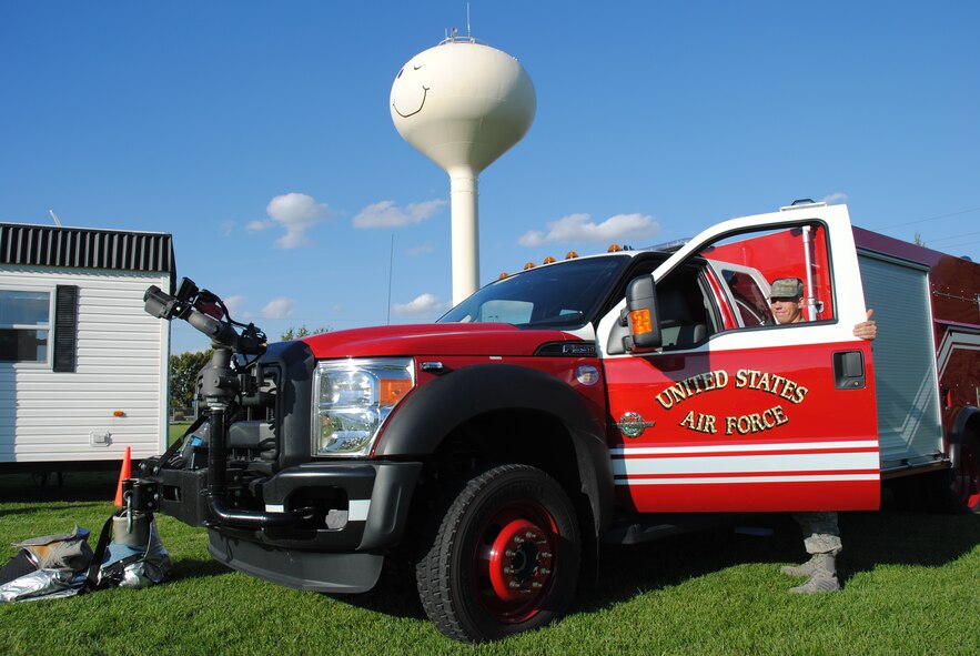 Grand Forks Air Force Base Fireman Airman 1st Class Cody Krissinger secures Rapid Incident Vehicle during the Grand Cities Community Celebration, Sept. 15, 2014, on the grounds of the Cliff Fido Purpur Arena in downtown Grand Forks. RIVs are lighter, smaller fire trucks used as a static display by the base fire department at community events such as the GCCC. (U.S. Air Force photo/Staff Sgt. Luis Loza Gutierrez) 
