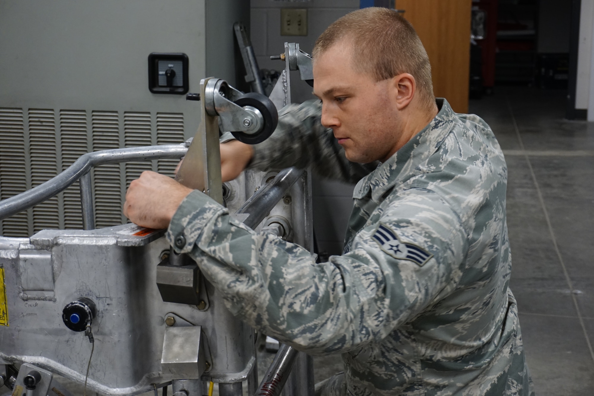 Senior Airman Aarron Hey, 90th Maintenance Operations Squadron Power, Refrigeration and Electrical, conducts a pre-maintenance check of a missile lauch facility work cage on F.E. Warren Air Force Base, Sept. 11, 2014. Hey is a member of the 90th MOS PREL team competing in the Air Force Global Strike Challenge. (U.S. Air Force photo by Lan Kim)