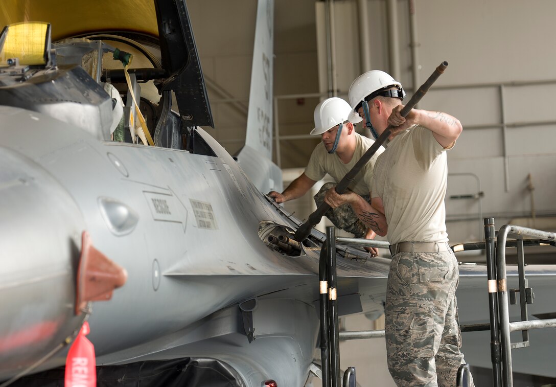 Tech. Sgt. Hunter Pettit and Tech. Sgt. Shiloh Blanco, instructors for 363rd Training Squadron, removed and installed an M61A1 20mm gun on a F-16 to acquire the firing solenoid for future training of armament students on Sept. 18, 2014 at Sheppard Air Force Base, Texas. The parts removed from the aircraft will be used for M61A1 gun training for over 120 students for fiscal year 2015 without having to spend money on parts.  (U.S. Air Force Photo Danny Webb/Released)