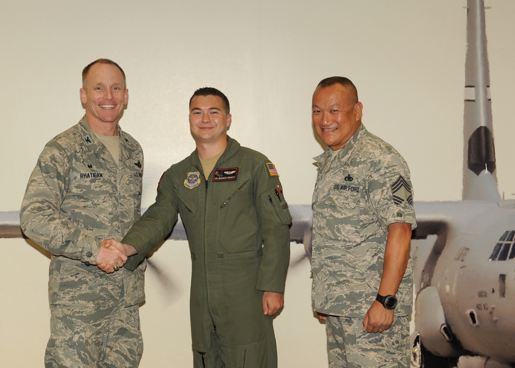 Col. Patrick Rhatigan, 19th Airlift Wing commander, along with Chief Master Sgt. Jimmy Ku, the 19th Maintenance Group command chief, congratulate Senior Airman Brandon Vernatt, a 41st Airlift Squadron loadmaster, on his selection as the Combat Airlifter of the Week Sept. 15, 2014, at Little Rock Air Force Base, Ark. Vernatt, a Snow Hill, N.C., native, played a crucial role in the recent preparation of the 41st AS deployment by ensuring 26 loadmasters completed their flying requirements prior to departure. (U.S. Air Force photo by Airman 1st Class Scott Poe)