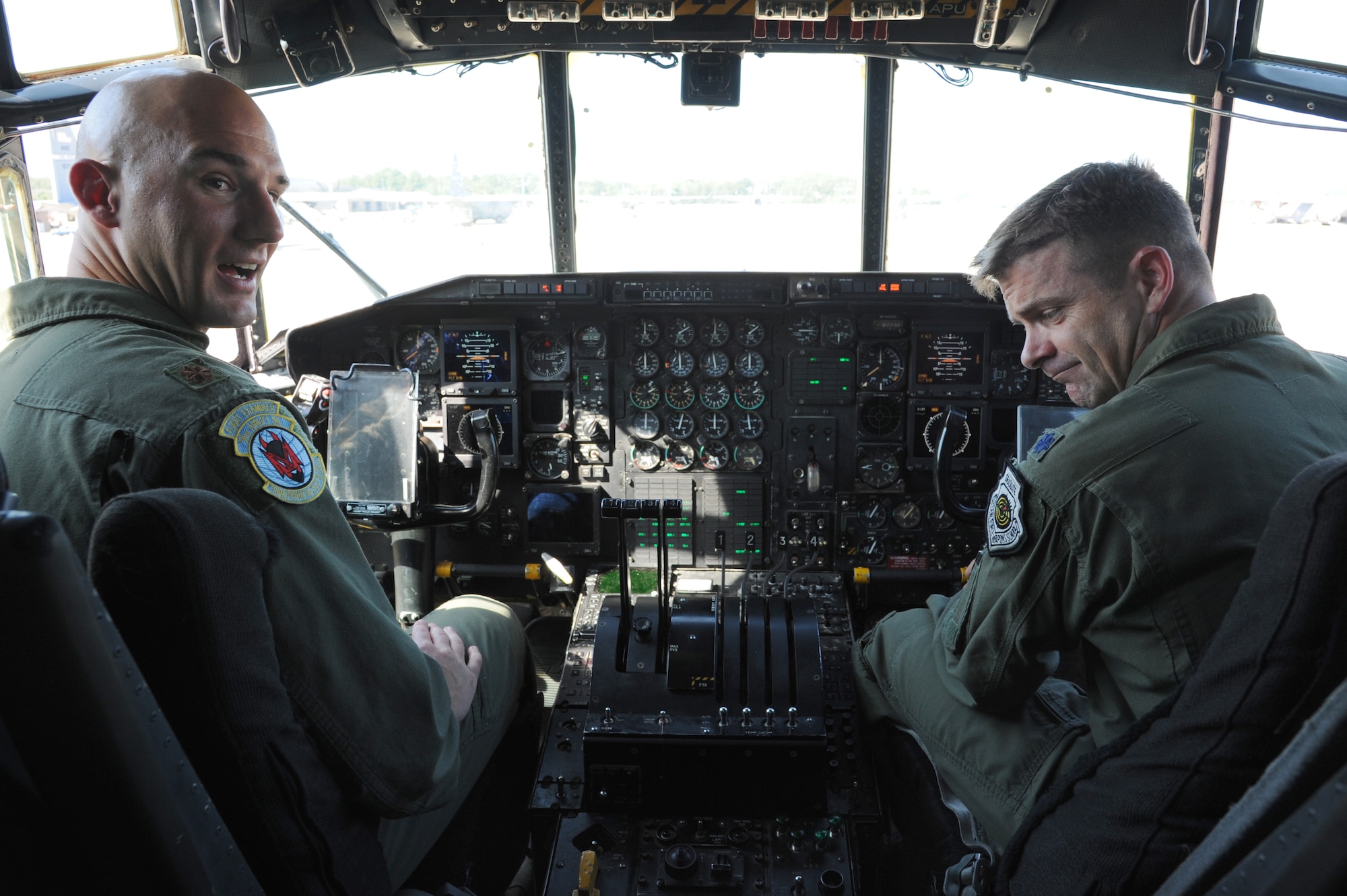 Maj. Justin Kershaw, 50th Airlift Squadron director of operations, and Lt. Col. Michael Fellona, 50th AS commander, reminisce in the cockpit of the last active-duty C-130H3 Sept. 3, 2014, at Little Rock Air Force Base, Ark.  Before the 50th AS becomes a total force association with the 913th Airlift Group, the squadron’s C-130H3 models were dispersed to Air Force Reserve and Air National Guard units all over the U.S. (U.S. Air Force photo by Airman 1st Class Mercedes Muro)