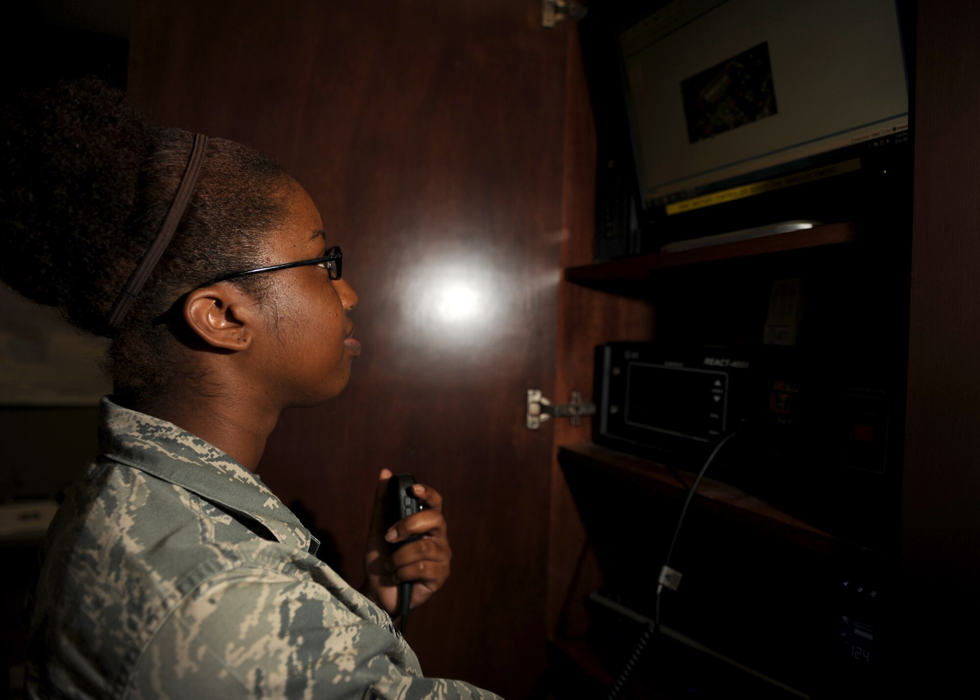 Senior Airman Kayla Lanier, a 19th Command Post emergency action controller, speaks on the “giant voice” system Sept. 11, 2014, at Little Rock Air Force Base, Ark. The “giant voice” system is used to play Reveille and Retreat, announce weather advisories, or even warn the base of potential threats. (U.S. Air Force photo by Airman 1st Class Scott Poe)