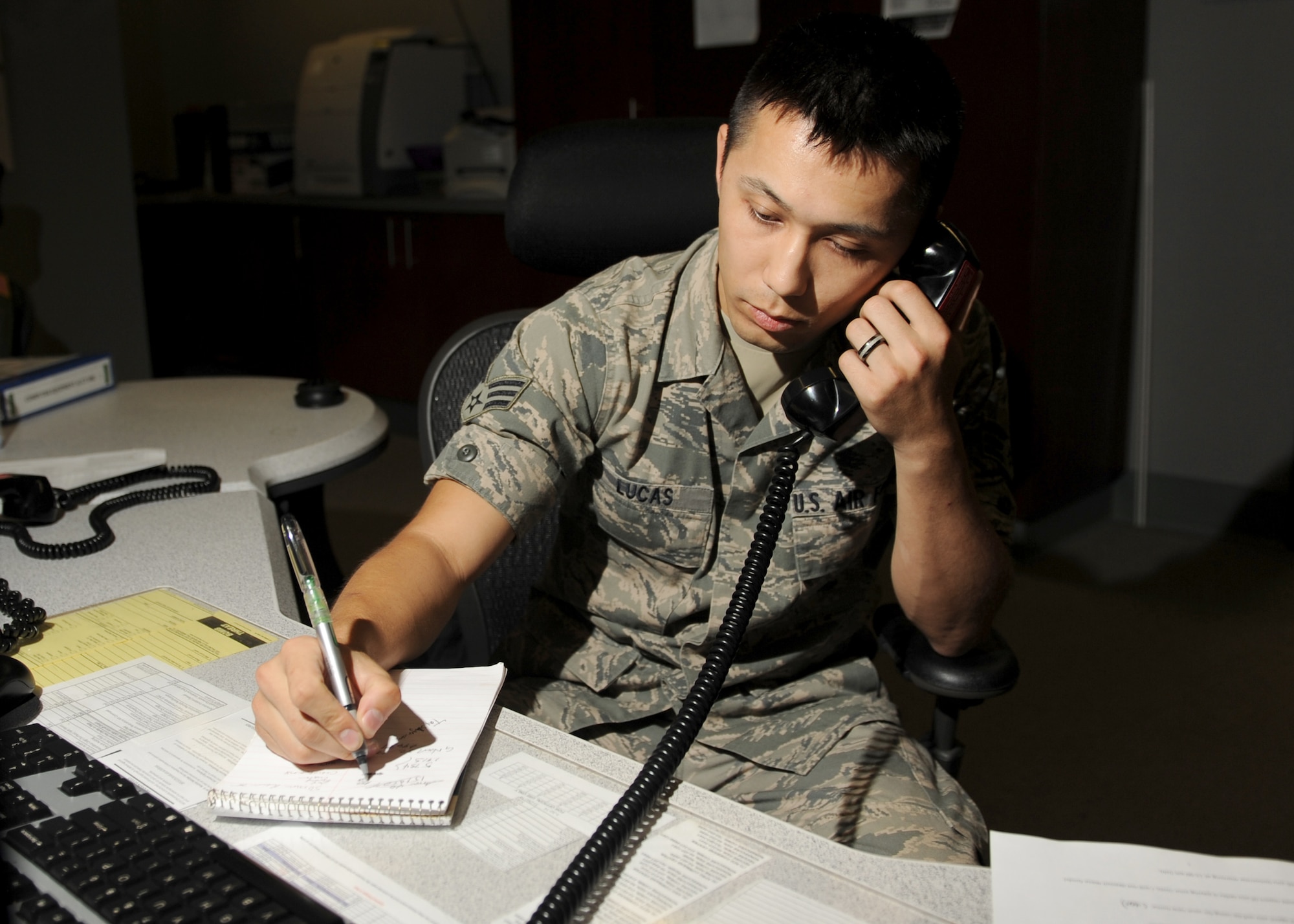 Senior Airman Jonathan Lucas, a 19th Command Post emergency action controller, gathers information from an incoming aircraft Sept. 11, 2014, at Little Rock Air Force Base, Ark. Command post controllers track aircraft, maintaining constant communication with the aircrew. (U.S. Air Force photo by Airman 1st Class Scott Poe)