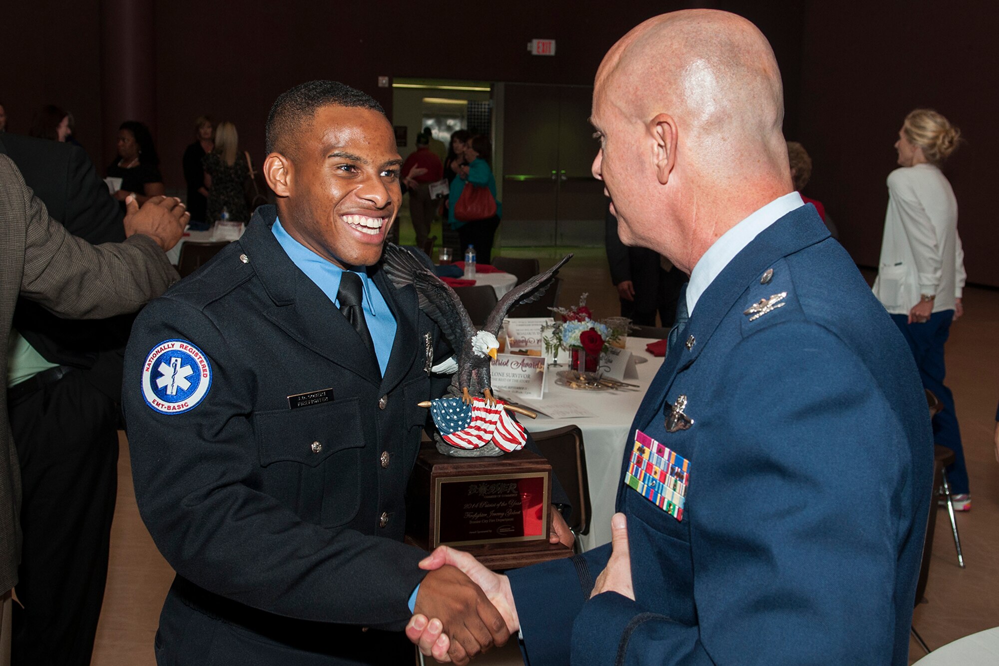 U.S. Air Force Senior Airman Jeremy Gobert, who is an Air Force Reservist assigned to the 307th Civil Engineer Squadron, is congratulated by Col. Jonathan Ellis, 307th Bomb Wing commander, after receiving the Patriot Award during a ceremony on Sept. 11, 2014, Bossier City, La. The ceremony is sponsored by the Bossier Chamber of Commerce and honors Bossier Parish military personnel, law enforcement, firemen and Emergency Medical Services. (U.S. Air Force photo by Master Sgt. Greg Steele/Released)