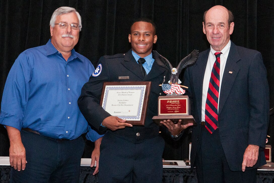 Jeremy Gobert, an Air Force Reserve Senior Airman assigned to the 307th Civil Engineer Squadron Firefighter, receives the Patriot Award during a ceremony on Sept. 11, 2014, Barksdale Air Force Base, La. The ceremony is sponsored by the Bossier Chamber of Commerce and honors Bossier Parish military personnel, law enforcement, firemen and Emergency Medical Services. (U.S. Air Force photo by Master Sgt. Greg Steele/Released)
