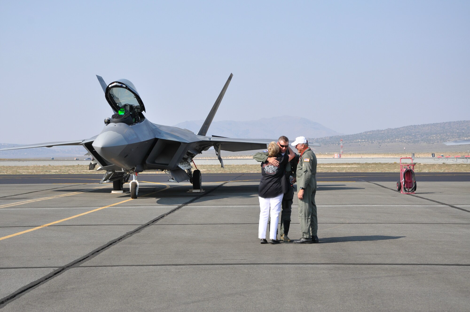 Lt. Col. Kevin Sutterfield is met by his parents Stan and Pat after landing his F-22 at Reno Sept. 9. Both Sutterfield and his father, Stan, competed in the 51st Annual National Air Races Sept. 10-14.  (U.S. Air Force/Maj. Ashley Conner)