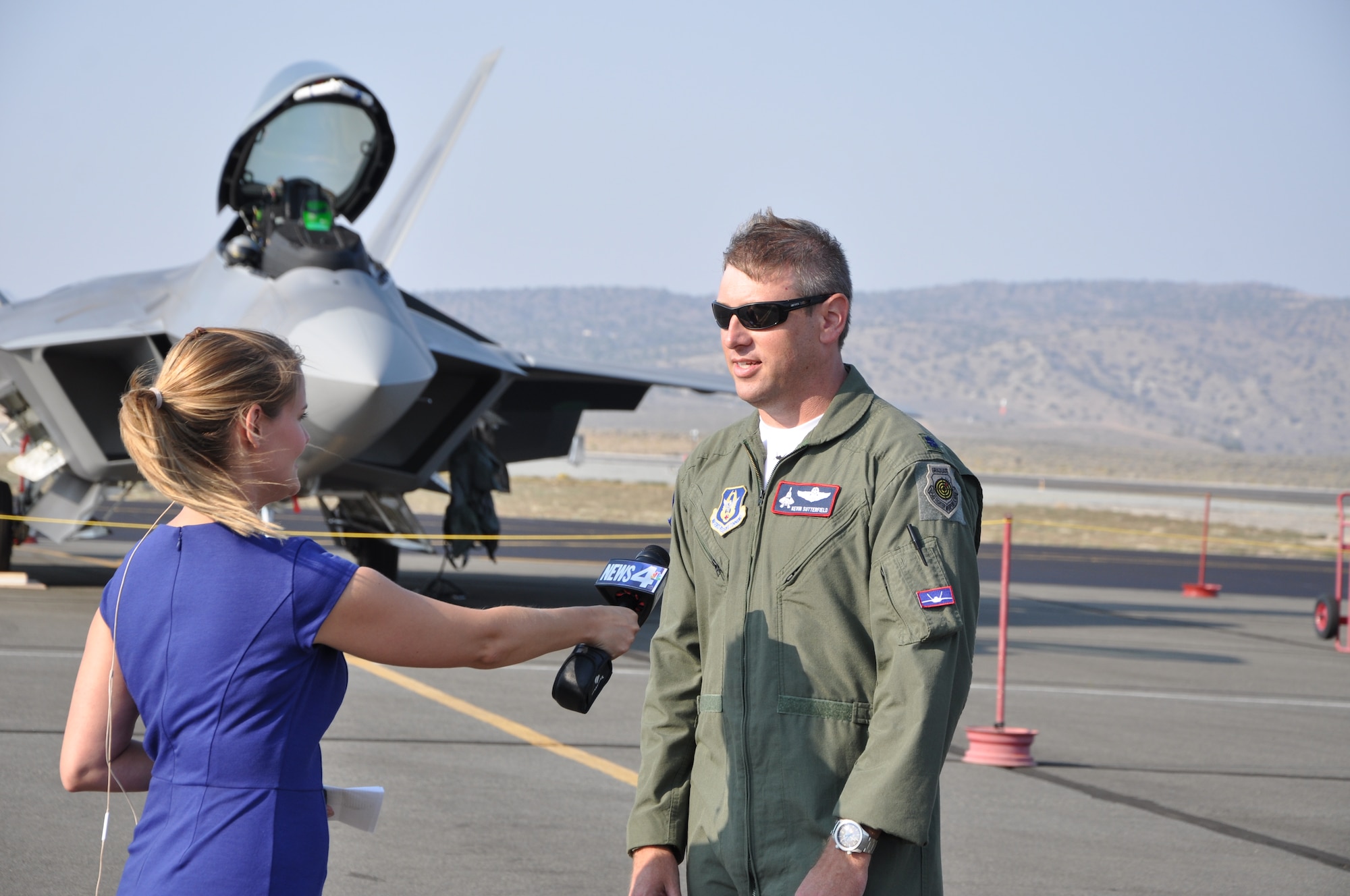 Lt. Col. Kevin Sutterfield is interviewed by Reno NBC affiliate reporter Ashley Cullins after flying an Alaska F-22 to Reno for the Reno Airshow Sept. 9. (U.S. Air Force/Maj. Ashley Conner) 