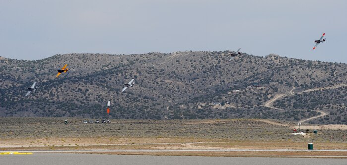 Several vintage fighter aircraft race for position around a pylon during the National Championship Air Races at Stead Airport, Reno, Nev., Sept. 13, 2014. Aircraft follow 50ft. pylons spread across a 3 to 8 mile course. (U.S. Air Force photo by Staff Sgt. Robert M. Trujillo/Released)
