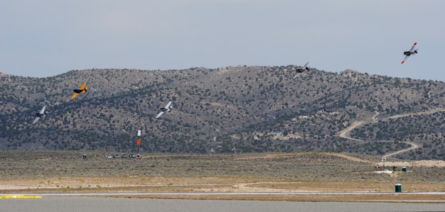 Several vintage fighter aircraft race for position around a pylon during the National Championship Air Races at Stead Airport, Reno, Nev., Sept. 13, 2014. Aircraft follow 50ft. pylons spread across a 3 to 8 mile course. (U.S. Air Force photo by Staff Sgt. Robert M. Trujillo/Released)