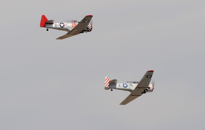 Two T-6 Texan aircraft race for position during National Championship Air Races in Reno, Nev., Sept. 13, 2014. These aircraft were used as trainers for the U.S. military for decades. (U.S. Air Force photo by Staff Sgt. Robert M. Trujillo/Released)