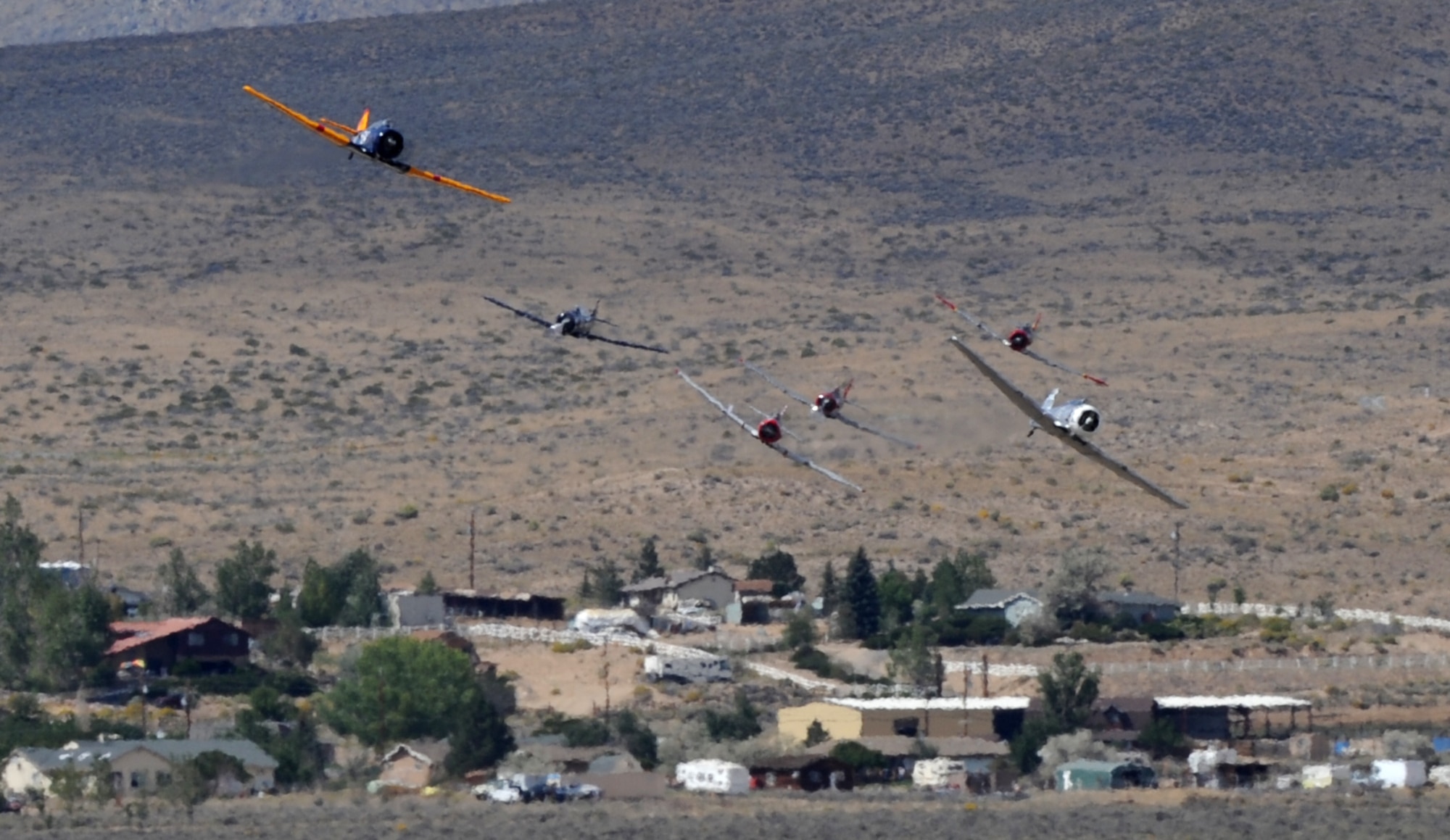 T-6 Texan aircraft race for position during the National Championship Air Races in Reno, Nev., Sept. 13, 2014. These aircraft were used as trainers for the U.S. military for decades. (U.S. Air Force photo by Staff Sgt. Robert M. Trujillo/Released)