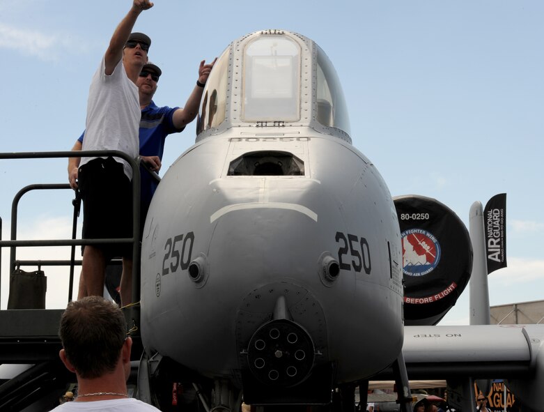 Air race fans view a static A-10 Thunderbolt during the National Championship Air Races in Reno, Nev., Sept. 13, 2014. The Thunderbolt is armed with seven-barrel 30mm Gatling gun. (U.S. Air Force photo by Staff Sgt. Robert M. Trujillo/Released)