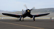 A F-4U Corsair performs a systems check prior to racing during the National Championship Air Races in Reno, Nev., Sept. 13, 2014. The Corsair is recognizable by its inverted gull wings. (U.S. Air Force photo by Staff Sgt. Robert M. Trujillo/Released)
