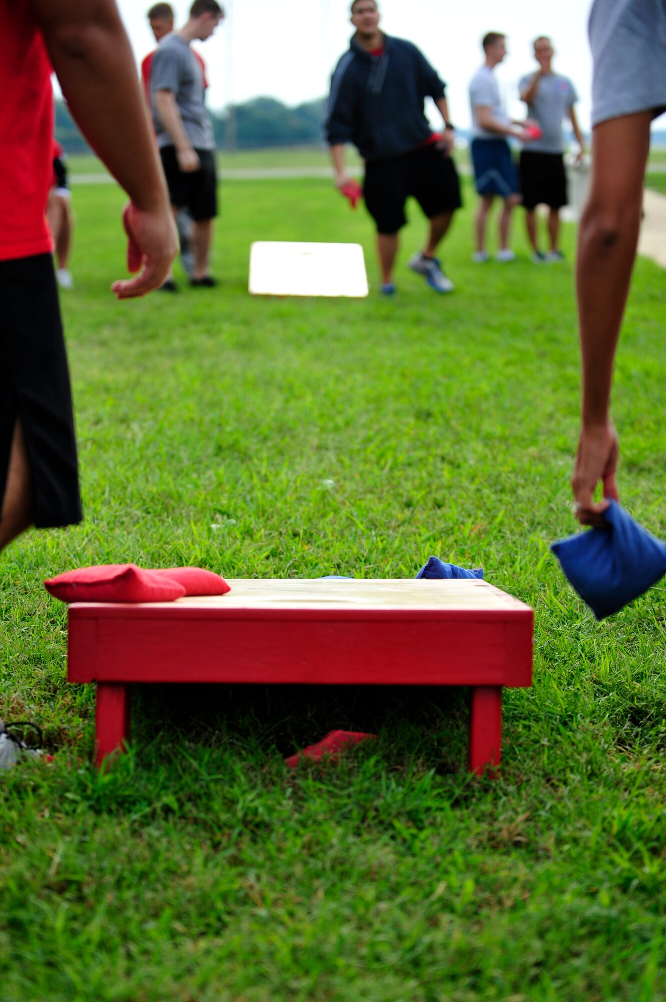U.S. Service members toss bean bags across a field during the 2014 480th Intelligence, Surveillance and Reconnaissance Wing Warrior Challenge outside the 497th ISR Group at Langley Air Force Base, Sept. 17, 2014. Other warrior challenge activities included a sit-up and push-up challenge and a tire flip. (U.S. Air Force photo by Airman 1st Class Breonna Veal/Released)