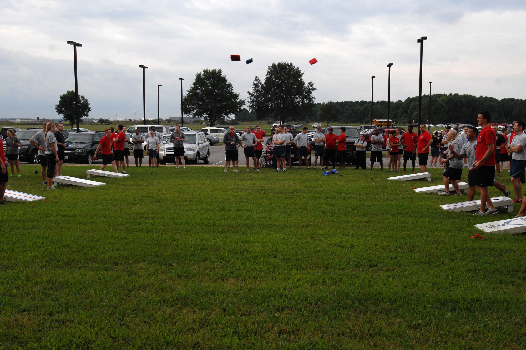 U.S. Air Force Airmen toss bean bags across a field during the 2014 480th Intelligence, Surveillance and Reconnaissance Wing Warrior Challenge at Langley Air Force Base, Sept. 17, 2014. This year, the 480th ISR Wing dedicated their annual warrior challenge to Senior Airman Russell Mountain, an analyst who has recently passed away. (U.S. Air Force photo by Airman 1st Class Breonna Veal/Released)