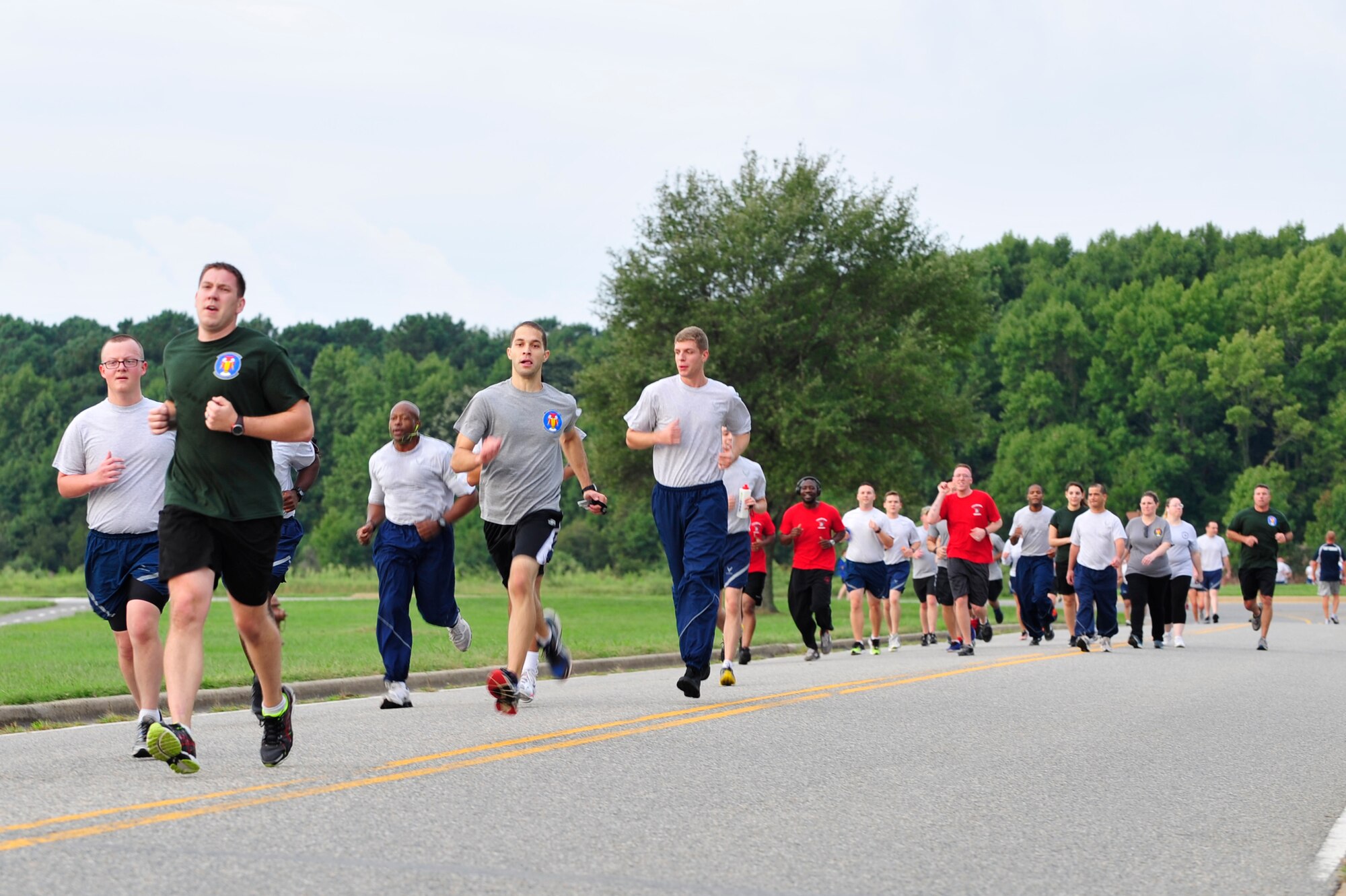 U.S. Air Force Airmen participate in a one-and-half-mile run during the 2014 480th Intelligence, Surveillance and Reconnaissance Wing Warrior Challenge outside the 497th ISR Group at Langley Air Force Base, Sept. 17, 2014. The events also included volleyball, a tire flip and a rucksack march. (U.S. Air Force photo by Airman 1st Class Breonna Veal/Released)