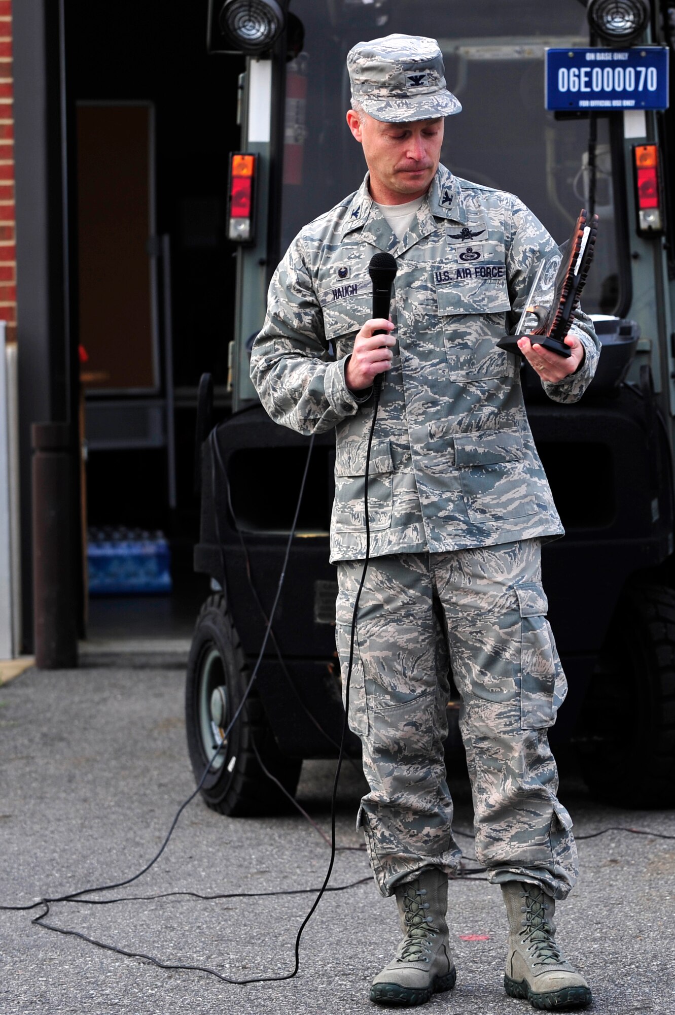 U.S. Air Force Col. Timothy Haugh, 480th Intelligence, Surveillance and Reconnaissance Wing commander, looks at a plaque memorial before the 2014 480th Intelligence, Surveillance and Reconnaissance Wing Warrior Challenge at Langley Air Force Base, Sept. 17, 2014. The plaque is inscribed with the name “Senior Airman Russell Mountain,” a 30th Intelligence Squadron analyst who has recently passed away. (U.S. Air Force photo by Airman 1st Class Breonna Veal)