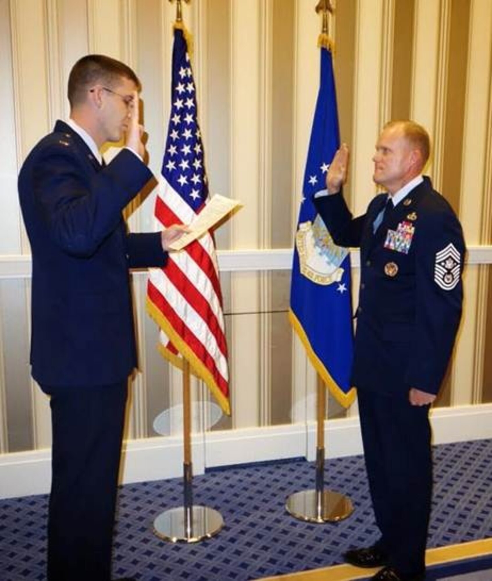 Second Lt. Nicholas Hiser, left, reenlists Chief Master Sgt. of the Air Force James Cody during the 2014 Air Force Association’s Air & Space Conference and Technology Exposition, Sept. 15, 2014, in Washington, D.C.  “This experience will always be memorable – I don’t know how I’ll top that,” Hiser said. “This will be a moment I look back on and talk about when I’m old and gray.” (courtesy photo)