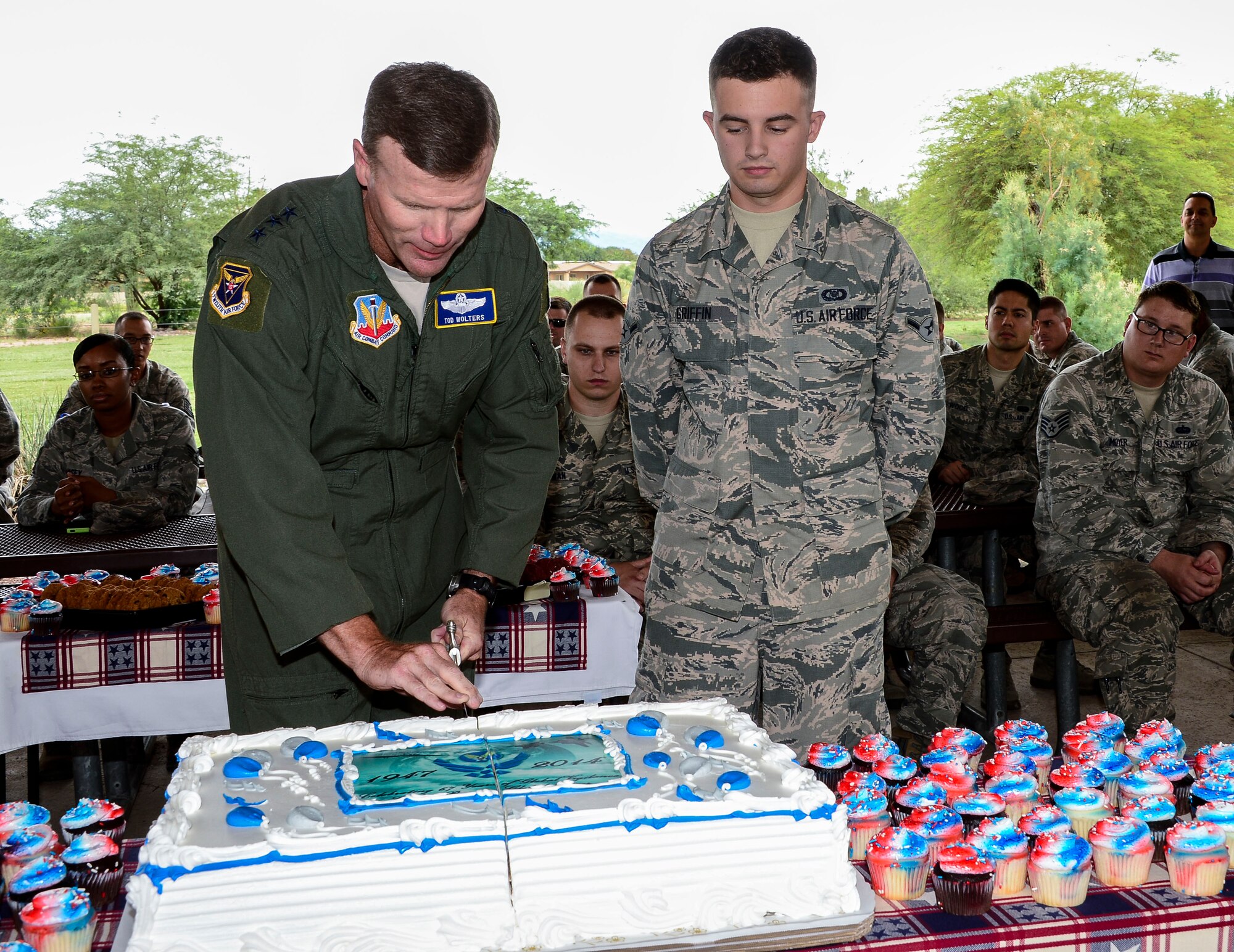 Lt. Gen. Tod Wolters, 12th Air Force (Air Forces Southern) commander, and Amn William Griffin, assigned to the 612th Air and Space Center, cut slices of cake during the 67th Air Force Birthday Celebration at Davis-Monthan AFB, Ariz., Sept. 18, 2014.  Founded on Sept. 18, 1947, President Harry S. Truman signed the National Security Act that not only established a new defense organization but also established the U.S. Air Force as an independent service.  Over the past 67 years the U.S. Air Force has made its mark in history and around the world as it focuses its efforts on maintaining air, space, and cyberspace superiority.  (U.S. Air Force photo by Tech. Sgt. Heather R. Redman/Released)