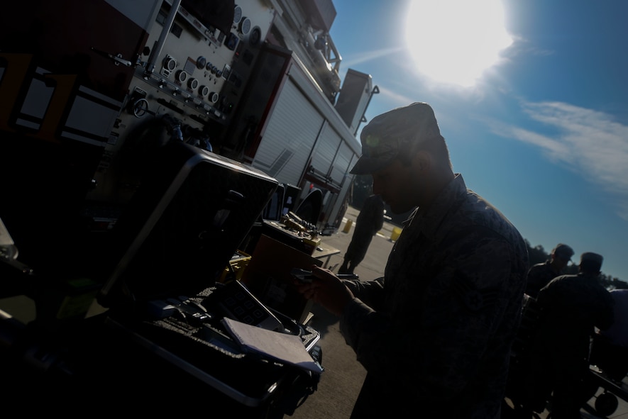 U.S. Air Force Staff Sgt. Scott Bell, 23d Aerospace Medicine Squadron bioenvironmental technician, inspects equipment during an exercise Sept. 18, 2014, at Moody Air Force Base, Ga. The 23d AMDS Bioenvironmental Engineering Flight trained with other emergency responders including the 23d Civil Engineer Squadron Fire Emergency Services Flight and the Emergency Management Flight. (U.S. Air Force photo by Airman 1st Class Dillian Bamman/Released)