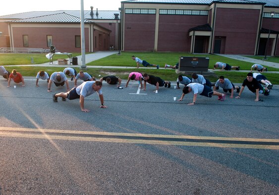 U.S. Air Force Chief Master Sgt. David Kelch, 23d Wing command chief, leads a group of Airmen in pushups after an Air Force birthday 5K run Sept. 18, 2014, at Moody Air Force Base, Ga. Kelch encouraged the 5K participants to join him in honoring the Air Force’s 67th birthday, 23d WG style, by doing 23 pushups. (U.S. Air Force photo by Senior Airman Jarrod Grammel/Released)
