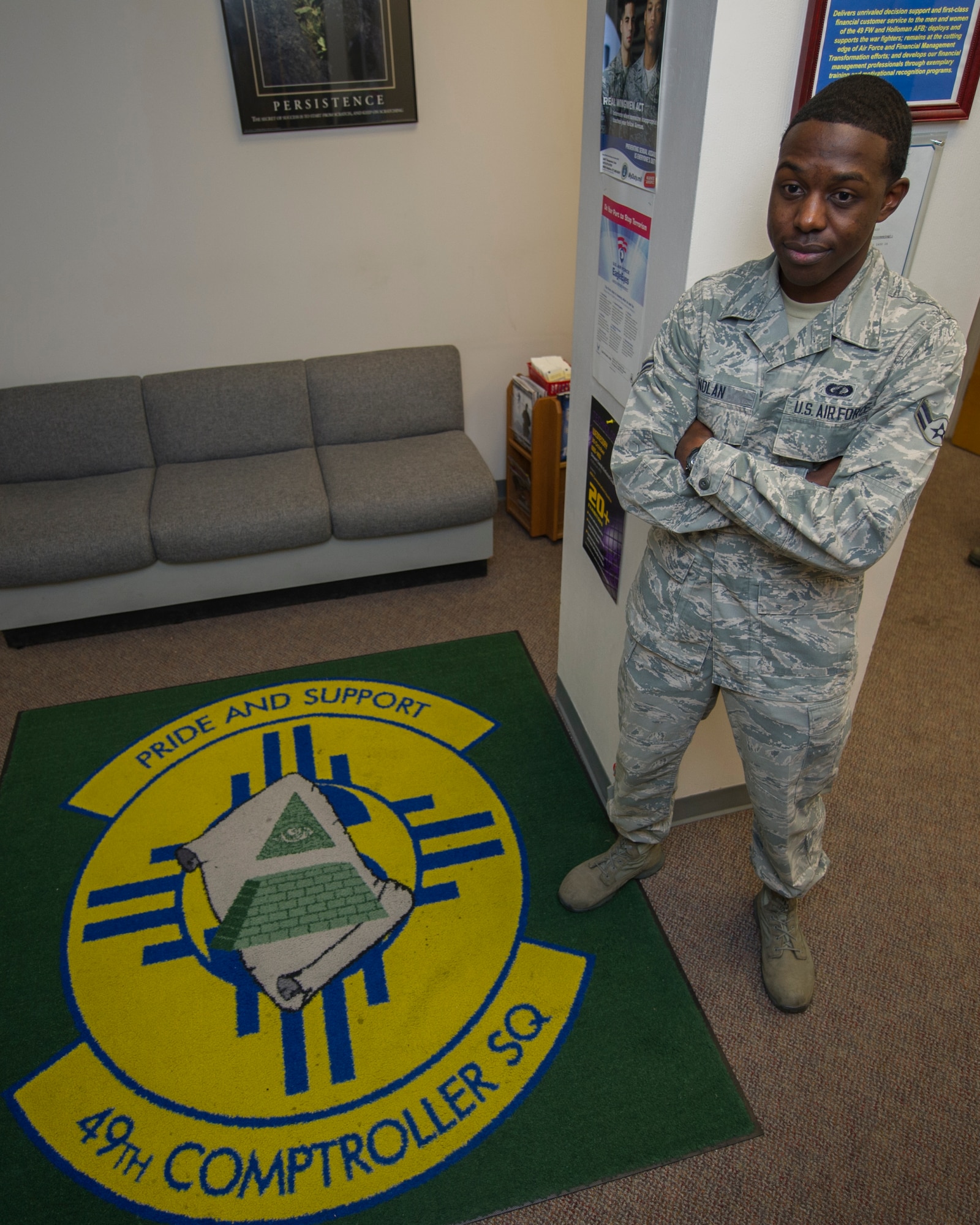 Airman 1st Class Windell Nolan, 49th Comptroller Squadron financial services technician, poses next to his squadron logo at Holloman Air Force Base, N.M., Sept. 18. Nolan, from Rowan Oak, Mississippi, celebrates the U.S. Air Force birthday in addition his regular duties. On September 18, 1947 the USAF was officially recognized as an independent military service, leaving behind its former role, the U.S. Army Air Corps. This year marks the 67th birthday, leading the world in air superiority, space and cyberspace. “The future of our nation is forever bound up in the development of Air Power,” Brigadier General Billy Mitchell, United States Army Air Service. (U.S. Air Force photo by Airman 1st Class Aaron Montoya / Released)