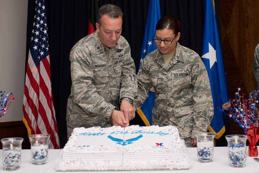 Brig. Gen. Patrick X. Mordente, 86th Airlift Wing commander, and Airman Basic Romary Castillo, 786th Force Support Squadron military personnel technician, cut a celebratory cake during the 67th Air Force birthday ceremony Sept. 18, 2014, at Ramstein Air Base, Germany. It is an Air Force tradition for the highest and the lowest ranking members to cut the cake during Air Force birthday celebrations. (U.S. Air Force photo/Senior Airman Jonathan Stefanko)