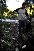 Chief Petty Officer Selectee Drew Staats, Naval Nuclear Power Training Command, collects debris from the Peas Hill Creek during a chief petty officer selectee community project Sept. 13, 2014, near James Island, S.C.. Chief selectees participate in COMREL projects as part of the CPO 365 Phase 2 training. The project was coordinated with Keep Charleston Beautiful, an organization that encourages local groups to volunteer for clean-up projects across the state by providing trash bags, gloves and any necessary supplies they might need. The chief selectees pinned on their anchors Sept. 16. (U.S. Air Force photo/Staff Sgt. Renae Pittman)